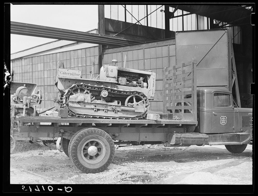 [Untitled photo, possibly related to: Hooking shepard crane to tractor preparatory to hoisting it off truck to repairs shop…