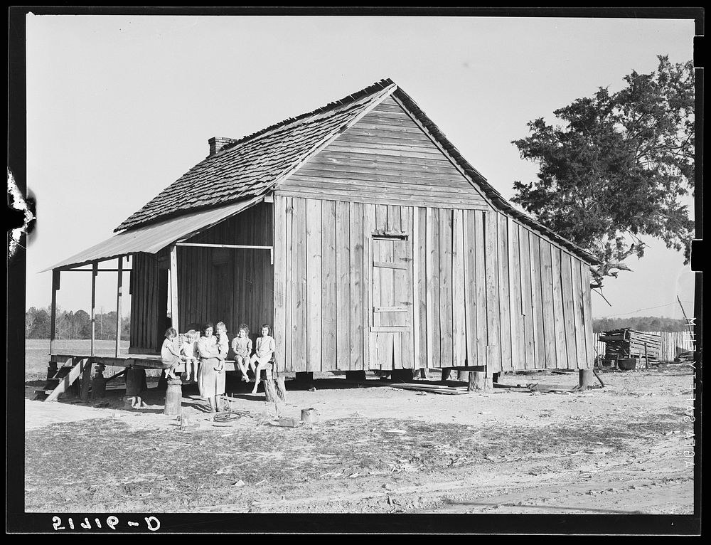 Mrs. Melody Tillery (RR-Rural Rehabilitation family) with her children on porch of their home. Pike County, Alabama. Sourced…