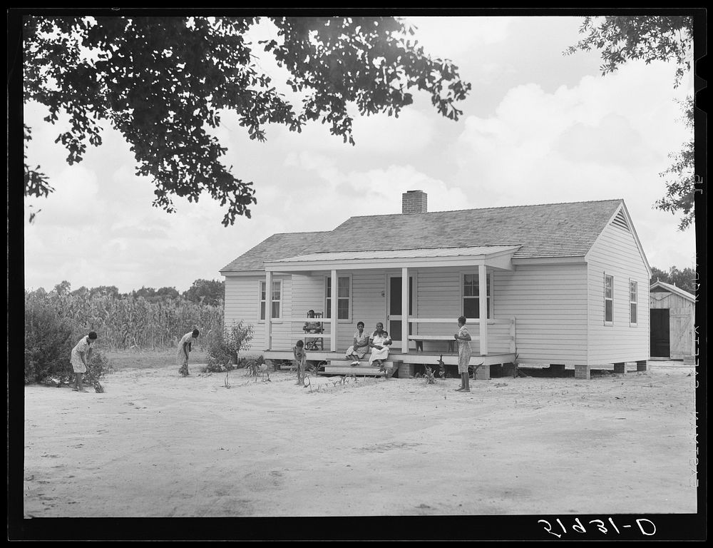 Children of Frederick Oliver, tenant purchase client, sweeping yard in front of new home. Summerton, South Carolina. Sourced…