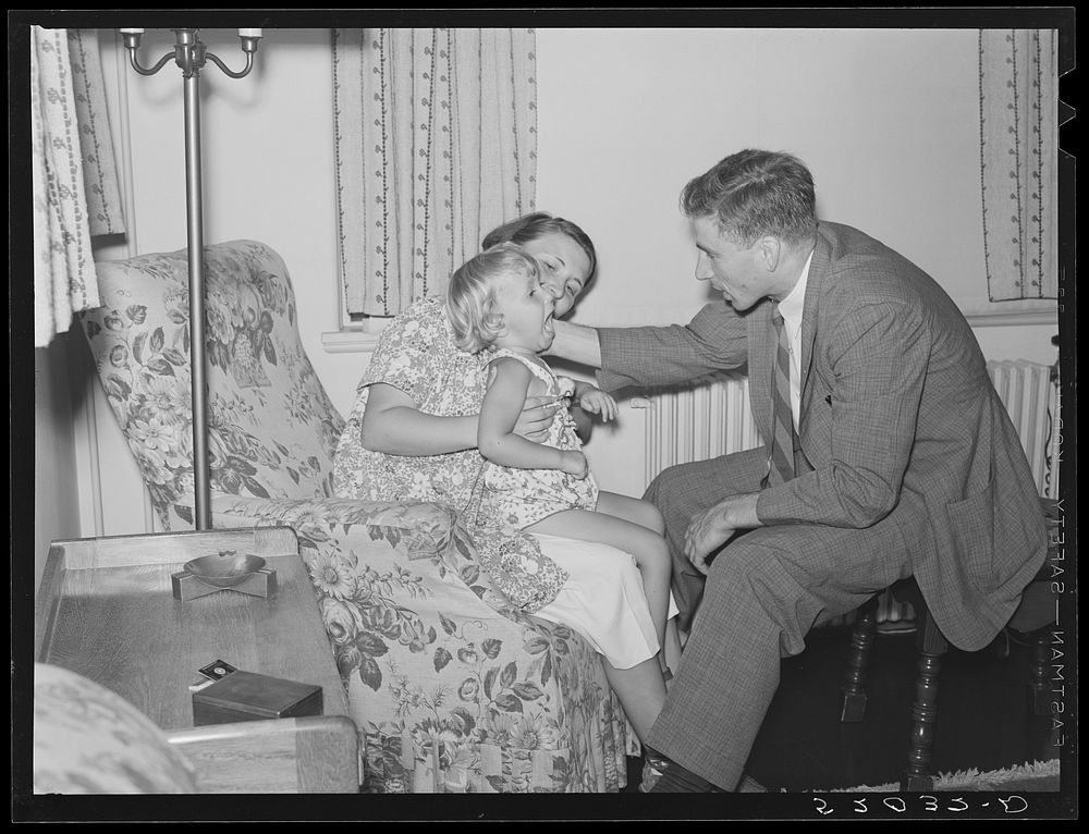 Doctor examining child in home. Greenbelt, Maryland. Sourced from the Library of Congress.