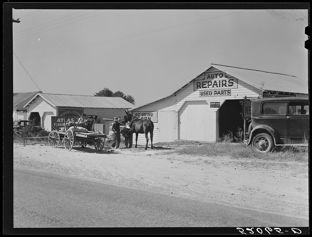 [Untitled photo, possibly related to: Combination filling station, garage, smith shop, grocery store. Frank Petty, owner of…