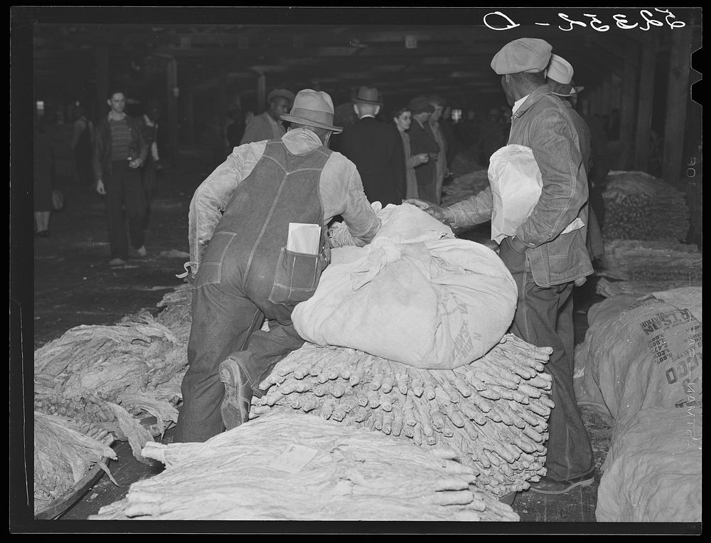Farmers waiting around at tobacco auction. Durham, North Carolina. Sourced from the Library of Congress.