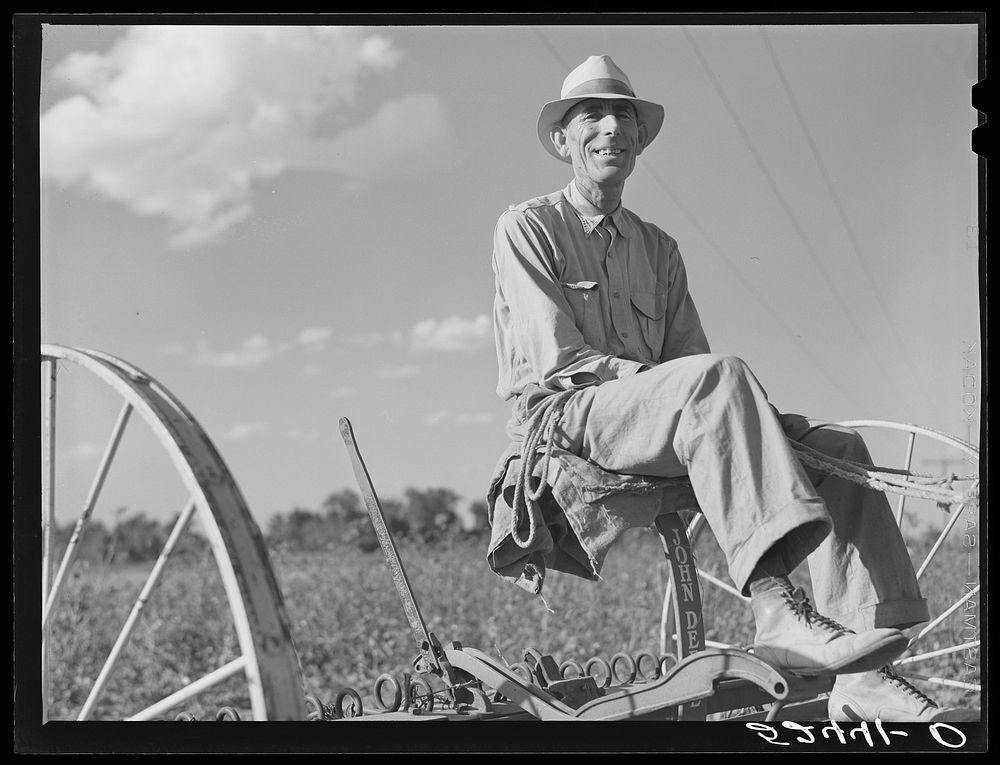 Tenant purchase client Mr. Crowell on his new hay rake. Mississippi Delta. Sourced from the Library of Congress.