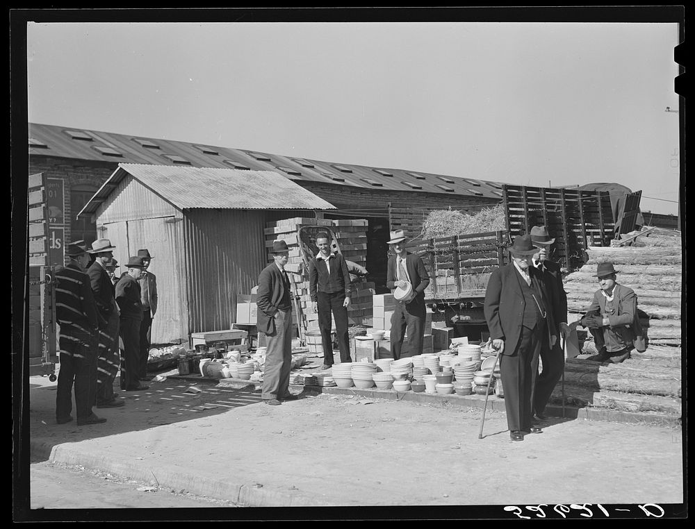 [Untitled photo, possibly related to: Farmers buying china from salesman outside tobacco warehouse during sales. Wendell…