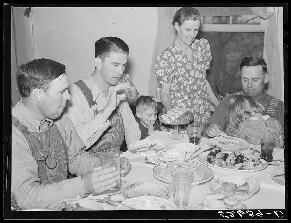 Mrs. Fred Wilkins passing cake to the men at dinner on corn-shucking day. Tallyho, Stem, Granville County, North Carolina.…