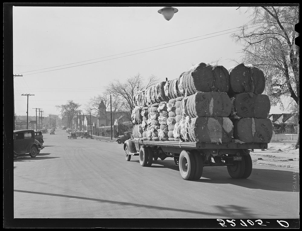 Truckload of bales of cotton on its way through town of Oxford. Granville County, North Carolina. Sourced from the Library…