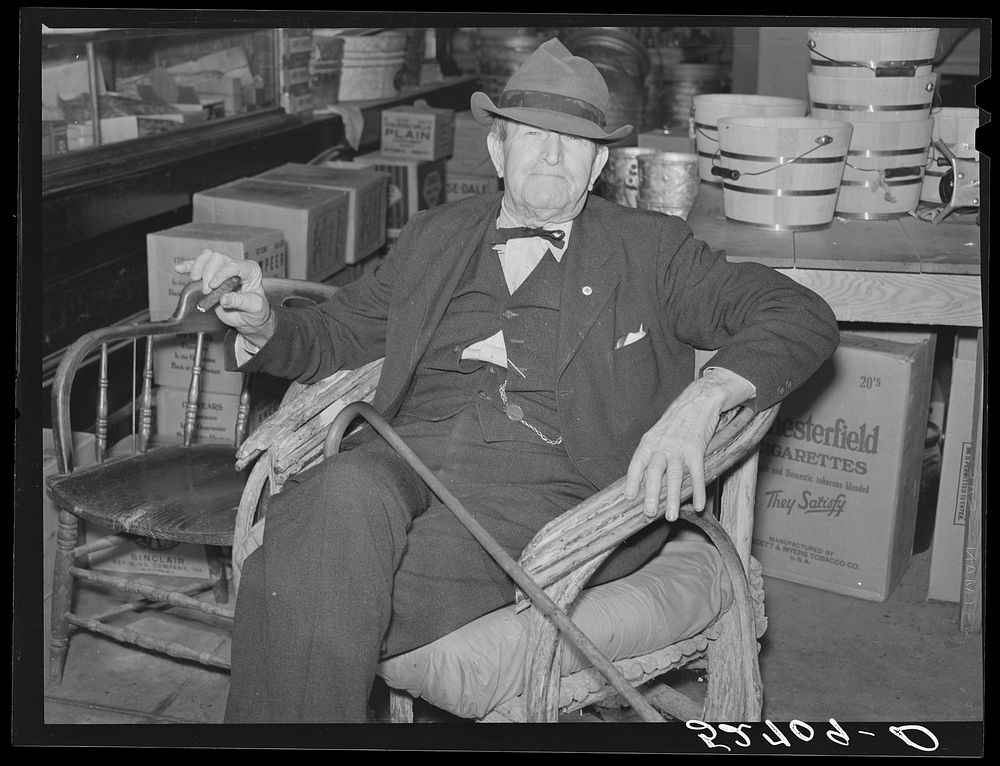 Mr. R.B. Whitley visiting in his general store. He is president of the bank and owns and runs practically all of the town…