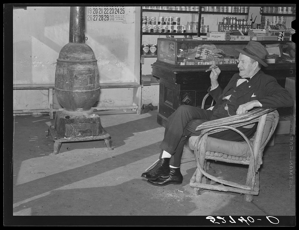 Mr. R.B. Whitley visiting in his general store. He is president of the bank and practically owns and runs the town. He is a…
