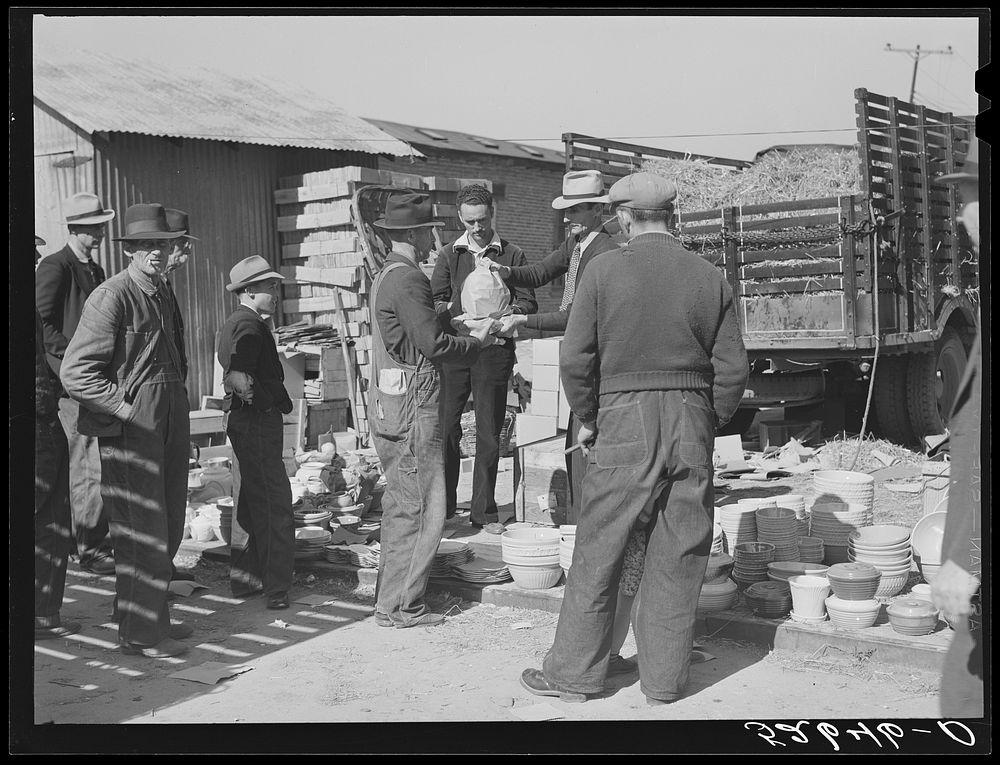 [Untitled photo, possibly related to: Farmers buying china from salesman outside tobacco warehouse during auction sales.…