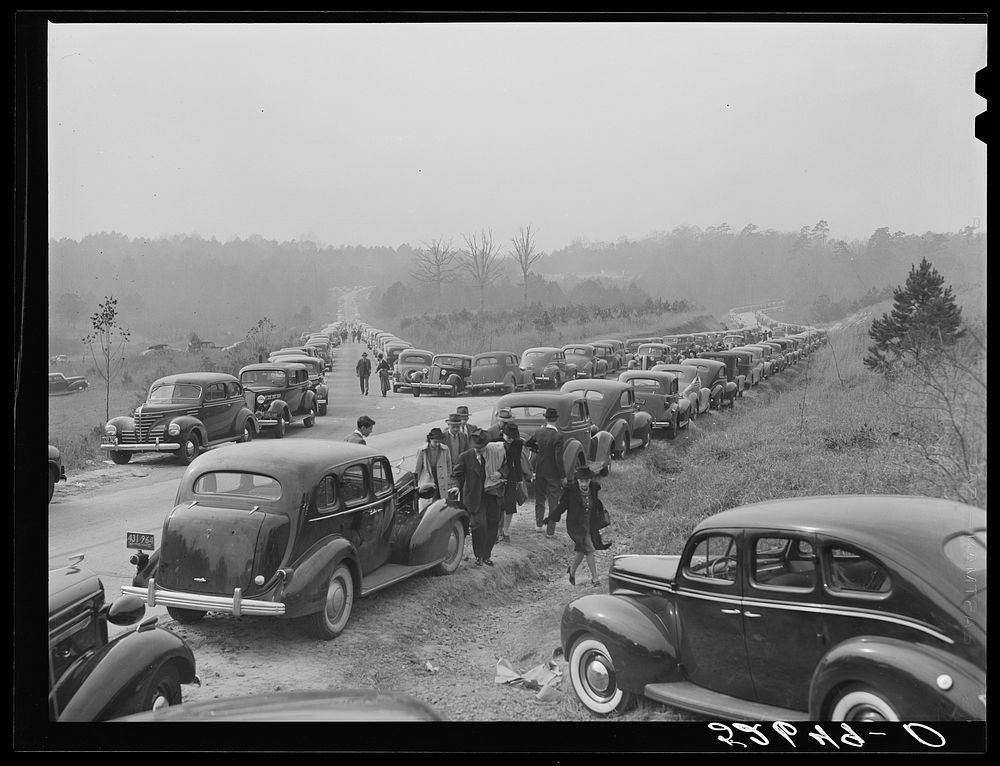 Cars parked along the highways on day of Duke-Carolina football game, near Duke University Stadium. Sourced from the Library…