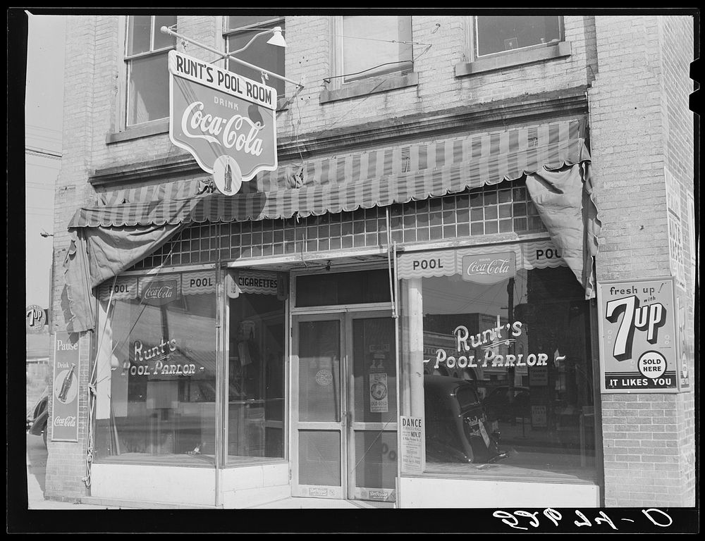 Runt's pool parlor with poster advertising a tobacco ball in window. Zebulon, Wake county, North Carolina. Sourced from the…