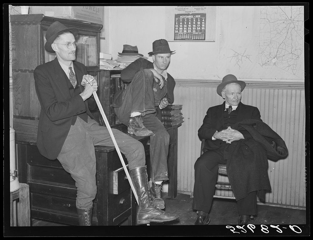 Group of men killing time during dinner hour in sheriff's office. Granville County Courthouse on court day in county seat.…