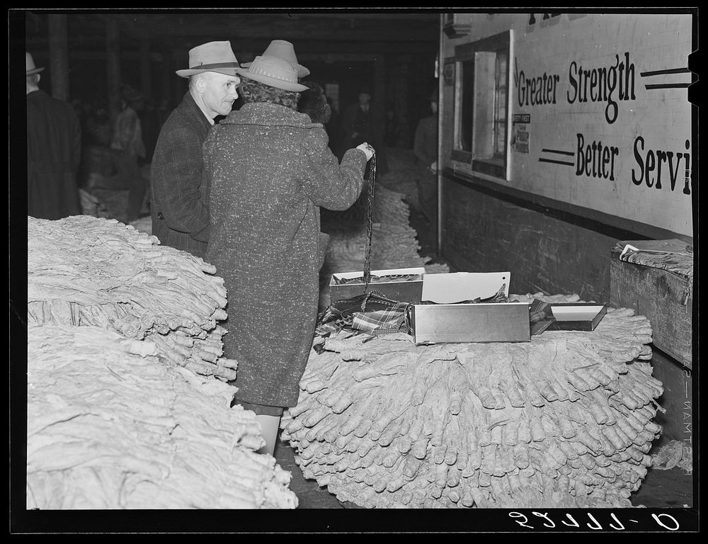 [Untitled photo, possibly related to: Farmers listening to sales talk of patent medicine vendor in warehouse during tobacco…