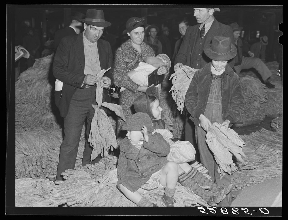 [Untitled photo, possibly related to: Farmers and friends waiting around in tobacco warehouse during auction sale. Durham…
