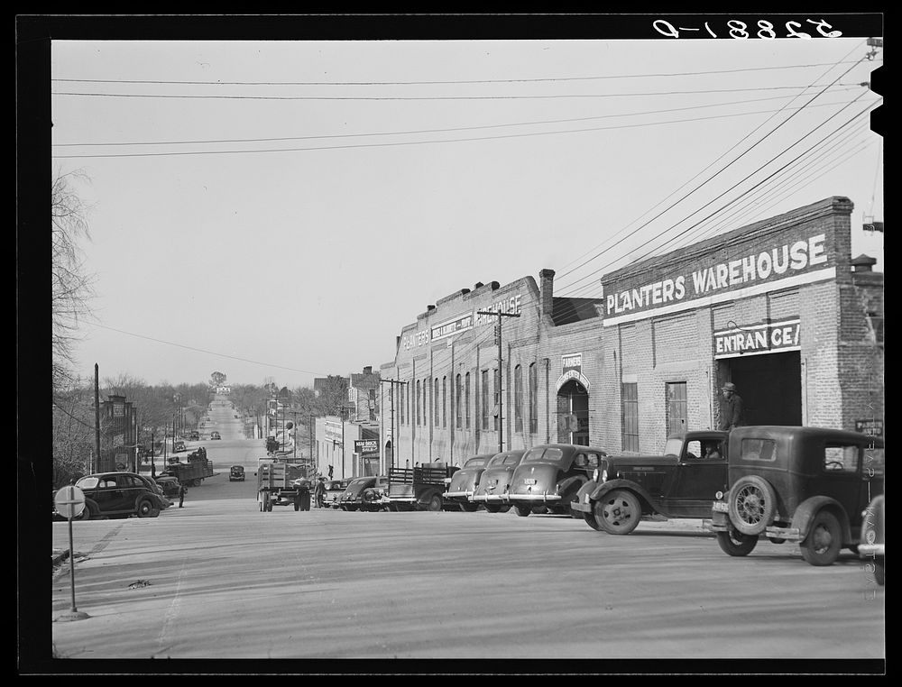 [Untitled photo, possibly related to: Tobacco warehouses on main street of South Boston, Halifax County, Virginia. A truck…