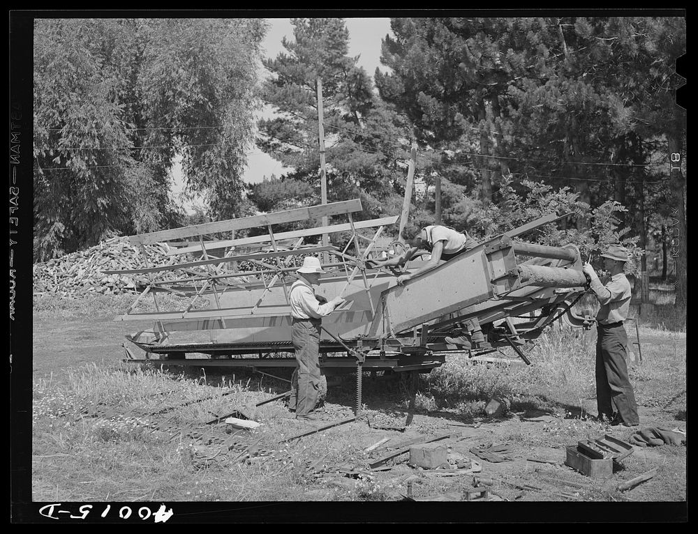 Repairing combine, getting ready for harvest. Genesee, Latah County, Idaho by Russell Lee