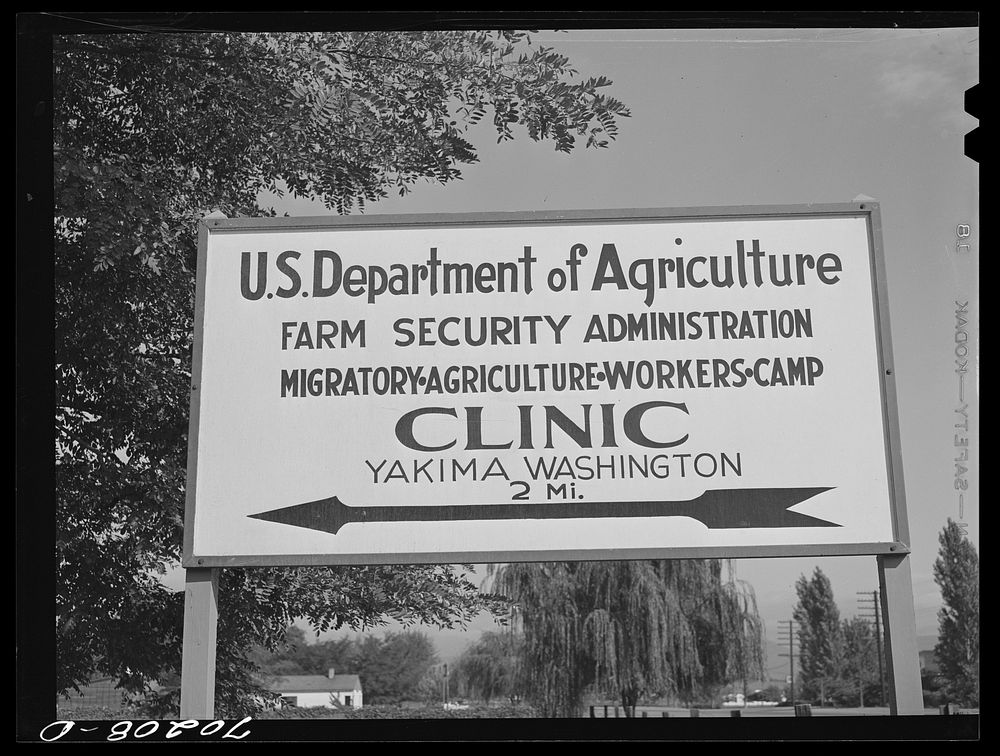 Sign, Yakima County, Washington. The clinic at FSA (Farm Security Administration) Labor Camps is a big drawing card by…