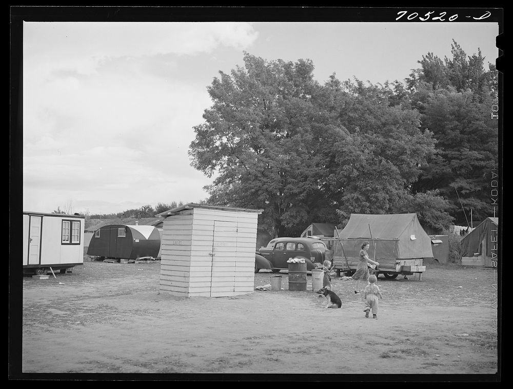 Trailer camp with sanitary facilities, garbage disposal in center. Hermiston, Oregon. This is typical of camps where workmen…