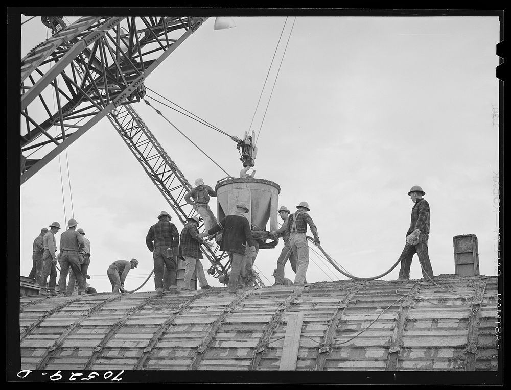 Pouring concrete in construction of one of the igloos at the Umatilla ordnance depot. Hermiston, Oregon by Russell Lee