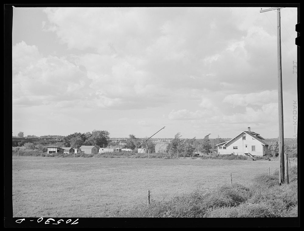 Trailers and other forms of temporary housing for workmen at the Umatilla ordnance depot ground near a farmhouse. Hermiston…