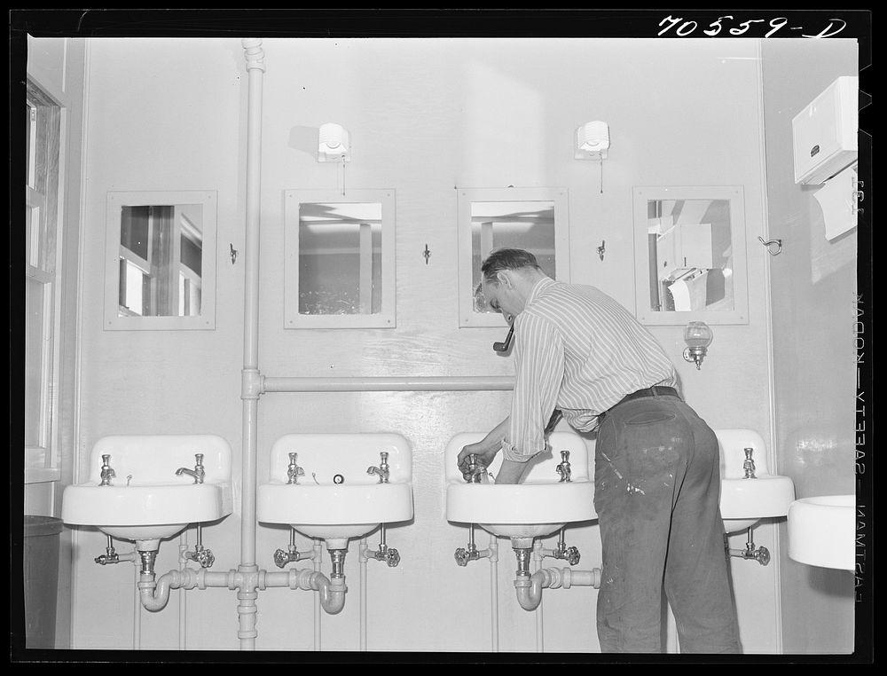 Workman at Navy shipyards, Bremerton, Washington, in the washroom at the FSA (Farm Security Administration) dormitories by…