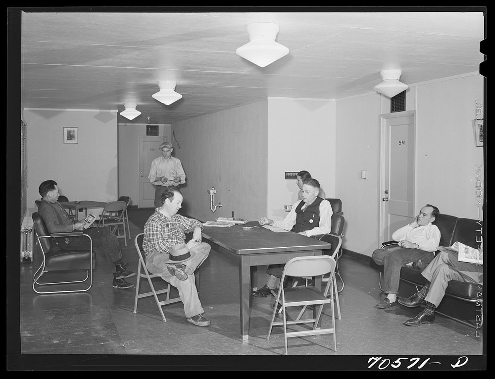 [Untitled photo, possibly related to: Men who work at the Navy shipyards in the community room at the FSA (Farm Security…