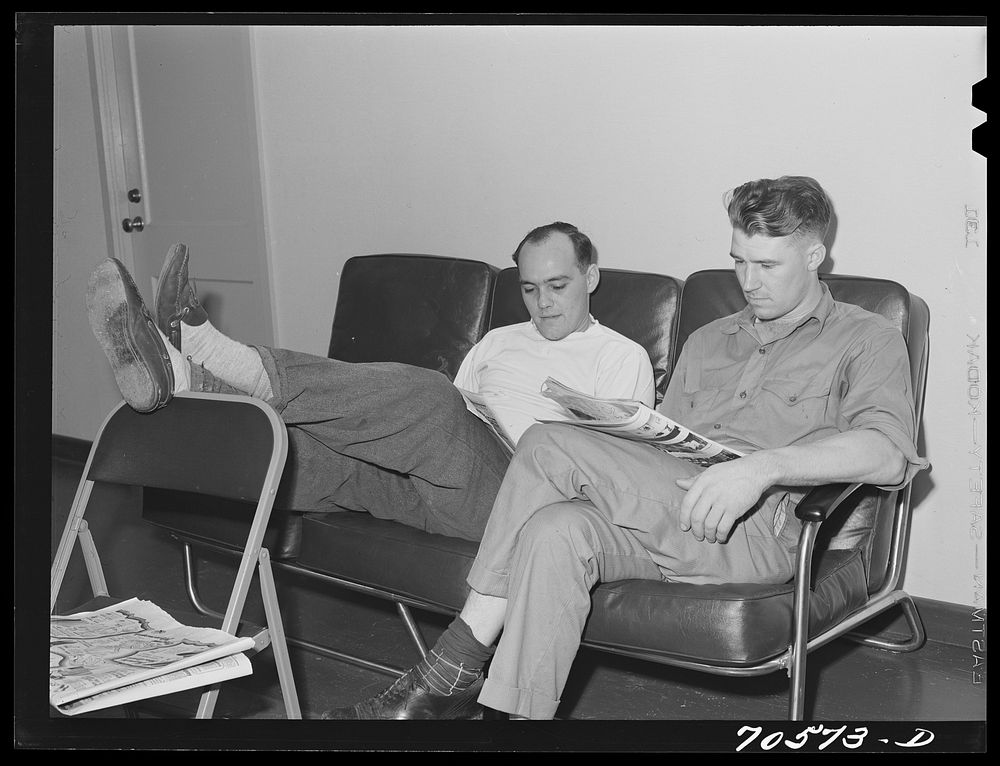 Workmen at the Navy shipyards in the community room at the FSA (Farm Security Administration) duration dormitories.…