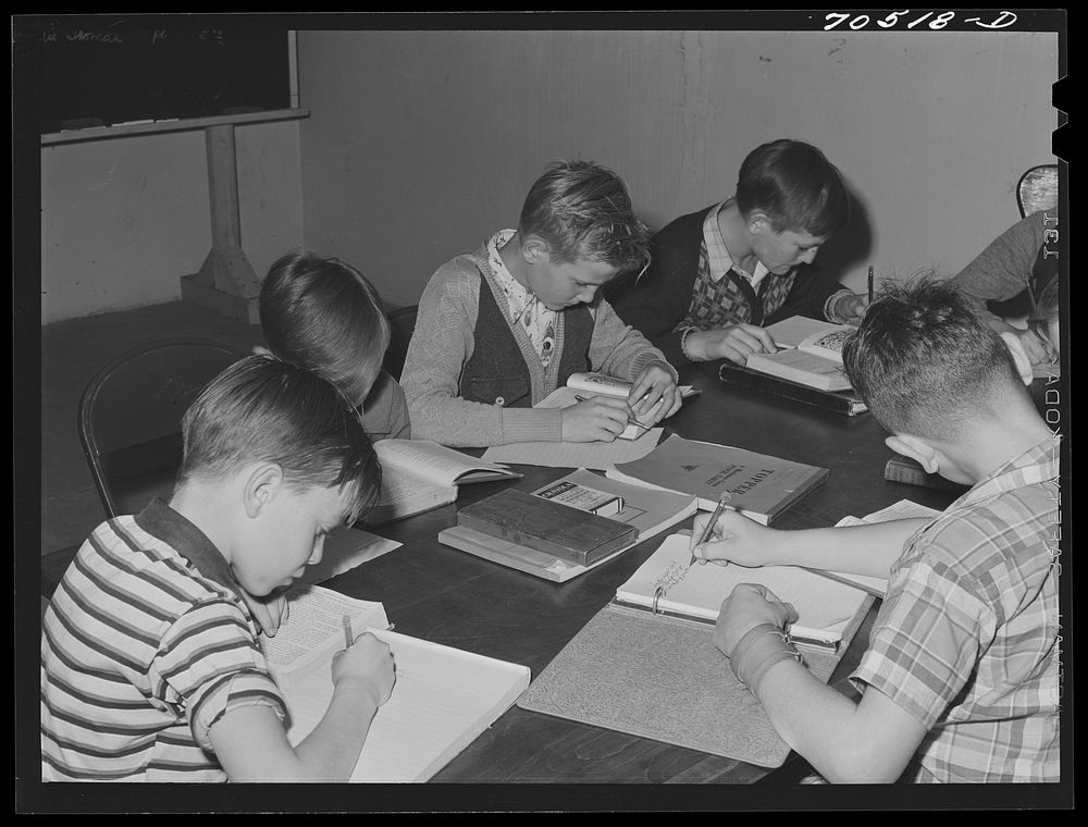 Children of workmen at the Umatilla ordnance depot attend school in basement of church, use long tables as desk. Hermiston…