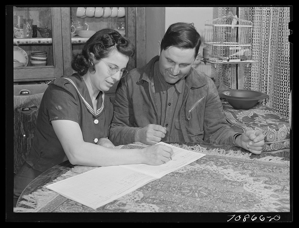 Mr. and Mrs. Lee Wagoner work on farm records. They live on the Black Canyon Project. Canyon County, Idaho by Russell Lee