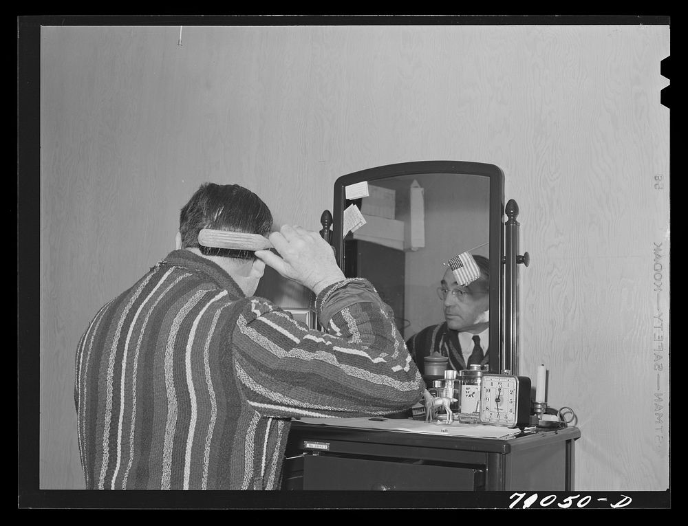Vallejo, California. Workman at Mare Island shipbuilding yards in his room at FSA (Farm Security Administration) dormitories…