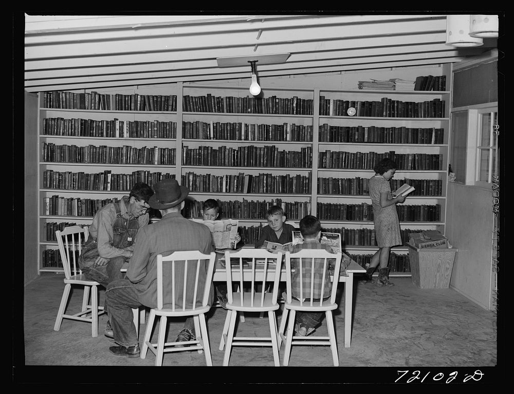 In the library of the FSA (Farm Security Administration) farm families community. Yuma, Arizona by Russell Lee