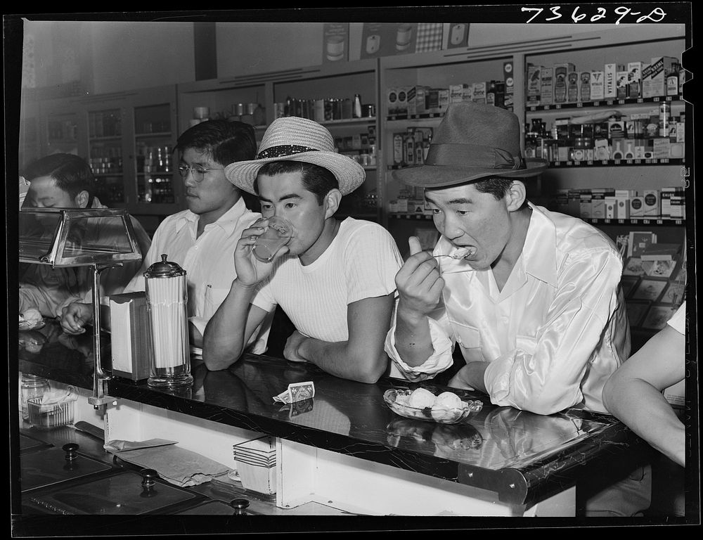 Nyssa, Oregon. Japanese-American boys at fountain of drugstore on their weekly visit to town by Russell Lee