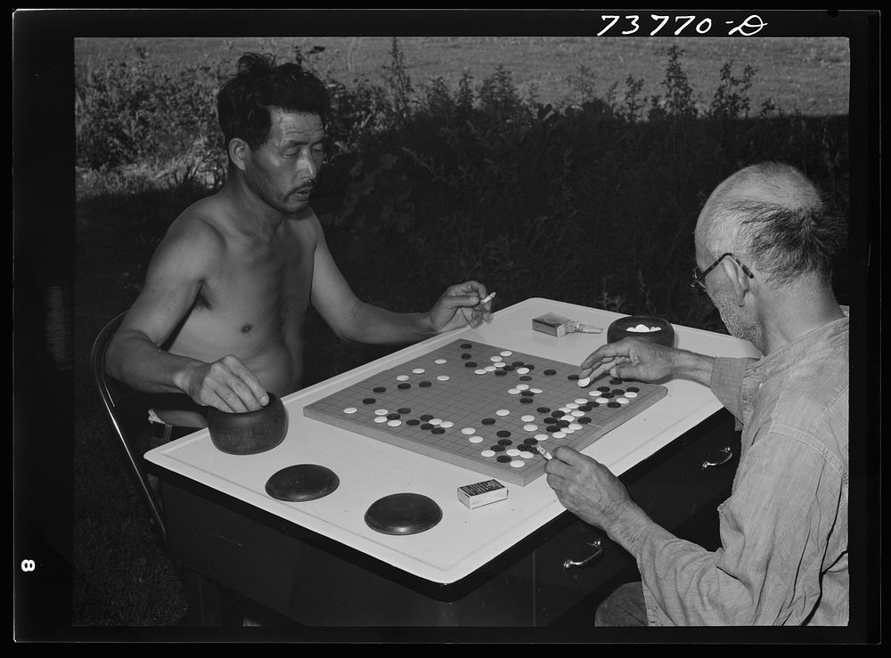 Twin Falls, Idaho. FSA (Farm Security Administration) farm workers' camp. Japanese farm workers play game of "Go" by Russell…