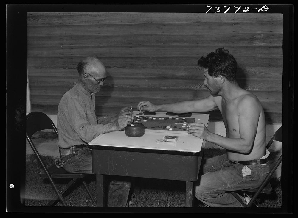 Twin Falls, Idaho. FSA (Farm Security Administration) farm workers' camp. Japanese farm workers play game of "Go" by Russell…
