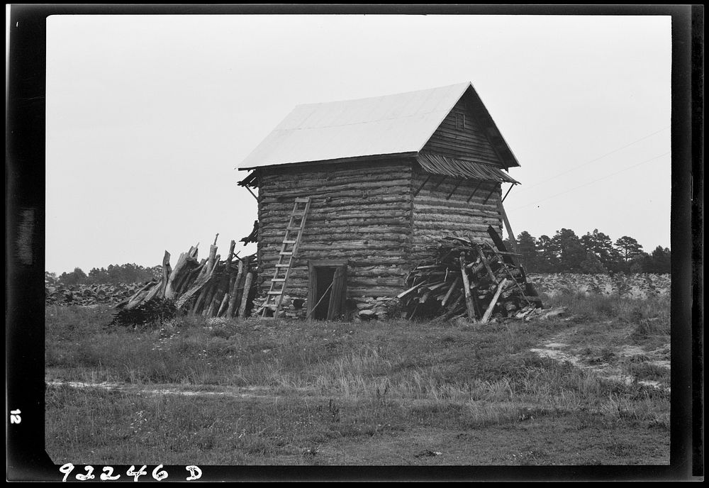 [Untitled photo, possibly related to: Tobacco barn without front shelter. The footpath across the field leads to the main…