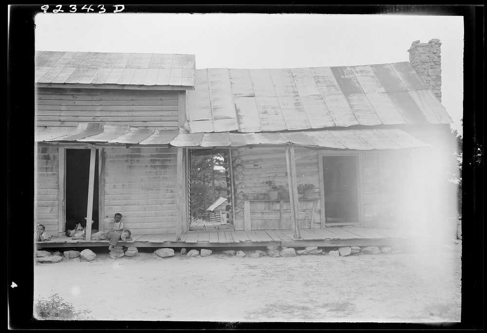 [Untitled photo, possibly related to:  sharecropper house on dirt. Dirt log cabin on right is much older than attached frame…