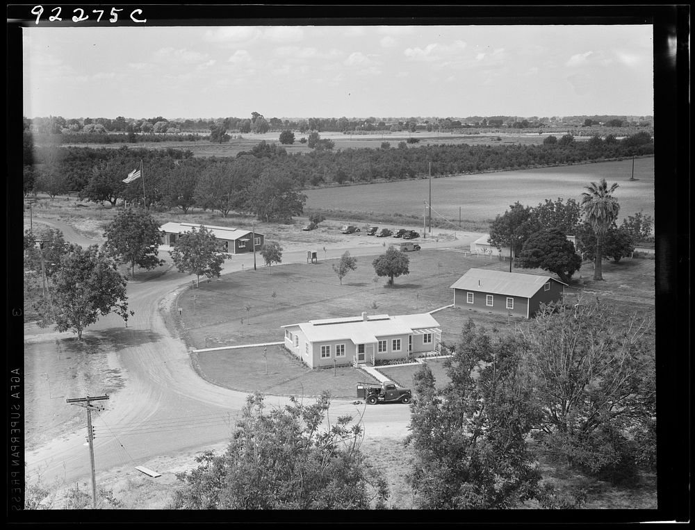 [Untitled photo, possibly related to: Entrance to camp showing clinic (light building in foreground). Same as 19635.…