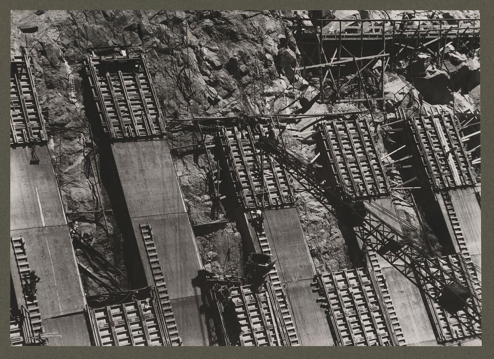 Boulder Dam, (i.e. Hoover Dam) between Arizona and Nevada. Placing concrete in the sidewall of the Nevada spillway. A 2…