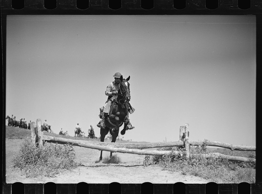 Fort Riley, Kansas. Soldiers of a cavalry machine gun platoon going over an obstacle during a field problem. Sourced from…