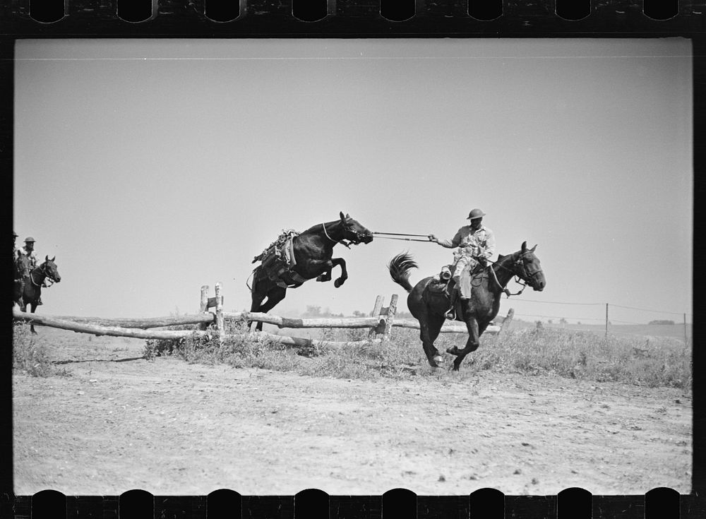 Fort Riley, Kansas. Soldiers of a cavalry machine gun platoon going over an obstacle during a field problem. Sourced from…