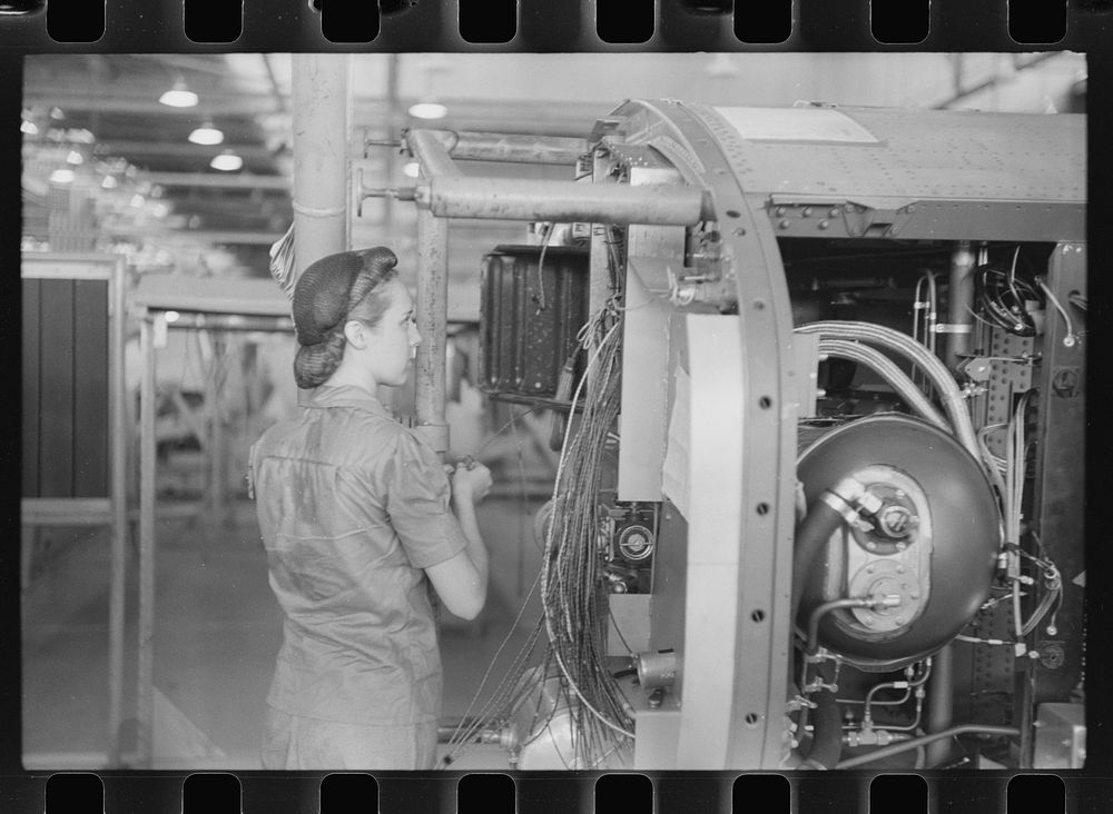 Nashville, Tennessee. Vultee Aircraft Company. Installing electric wiring in a fuselage. Sourced from the Library of…