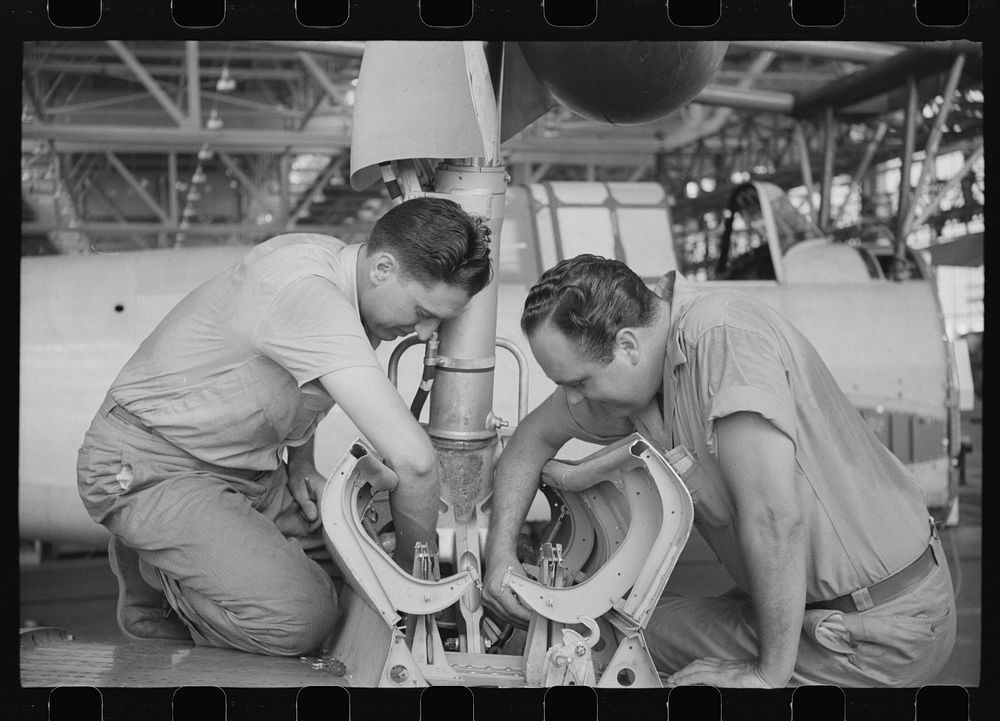 Nashville, Tennessee. Vultee Aircraft Company. Working on the landing gear of a bomber. Sourced from the Library of Congress.