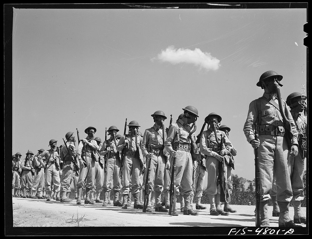 Edgewood Arsenal, Maryland. Gas demonstration. Soldiers wearing gas masks after having been sprayed with gas from a plane.…