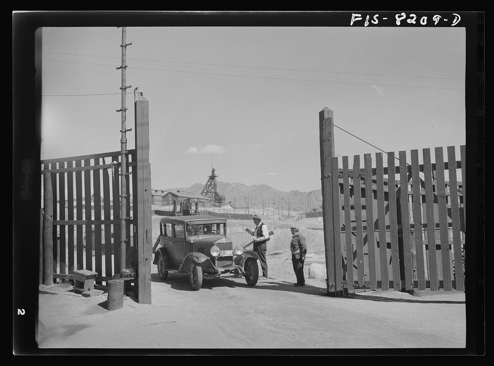 Butte, Montana. Anaconda Copper Mining Company. Guards at the gate of a copper mine by Russell Lee