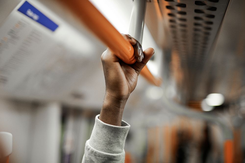 Man holding on to a handrail on a train
