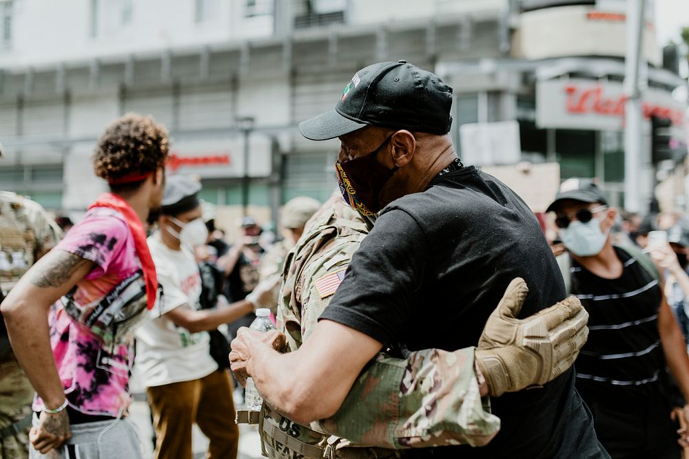 Soldier and protester hugging during the Black Lives Matter protest at Hollywood & Vine. 2 JUN, 2020, LOS ANGELES, USA