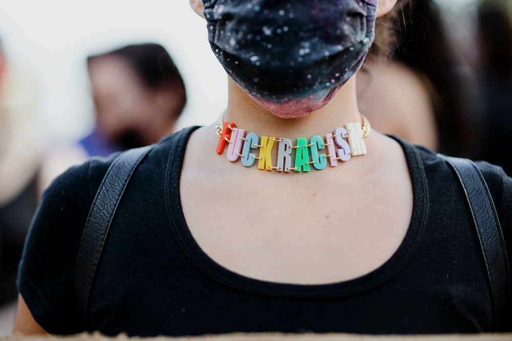 Protester wearing a Fuck Racism necklace at the Black Lives Matter protest in downtown Los Angeles.  8 JUL, 2020, LOS…