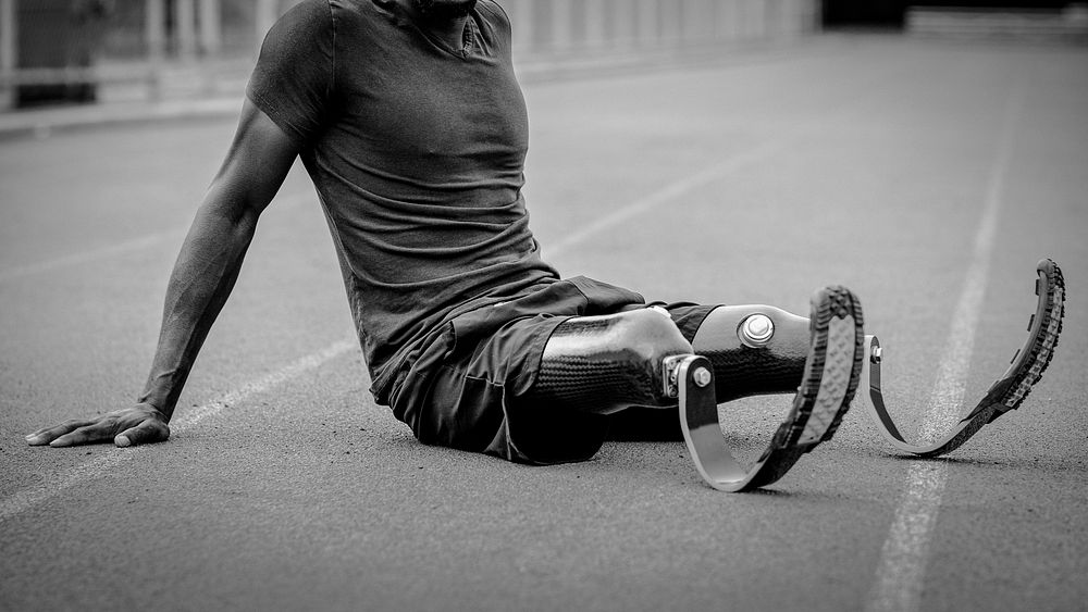 Paralympic athlete relaxing by the running track