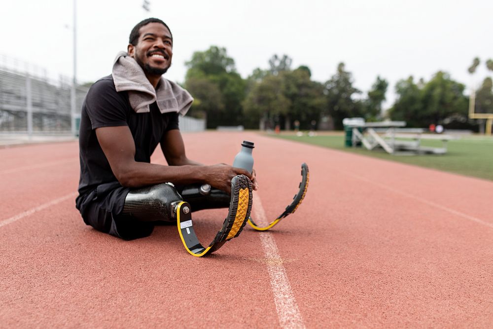 Paralympic athlete relaxing by the running track