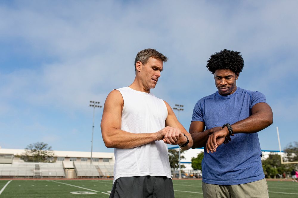 Athlete and coach discussing fitness tracker and performance